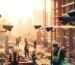 Multiple security cameras monitoring a busy construction site with workers in safety gear at sunset.