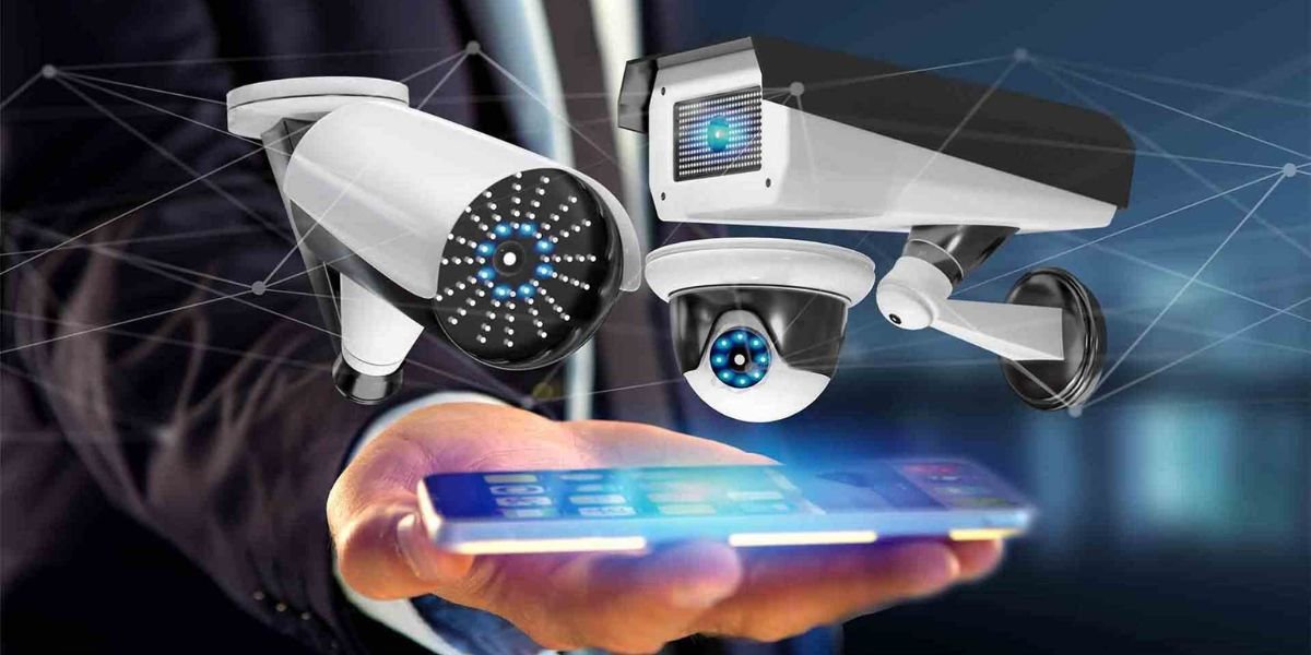 Hand holding smartphone with floating CCTV security cameras connected by digital network lines.