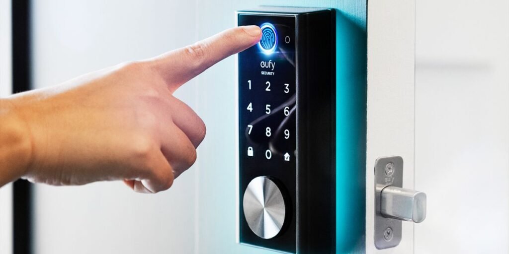 Person using fingerprint scanner on a smart digital door lock with keypad for home security