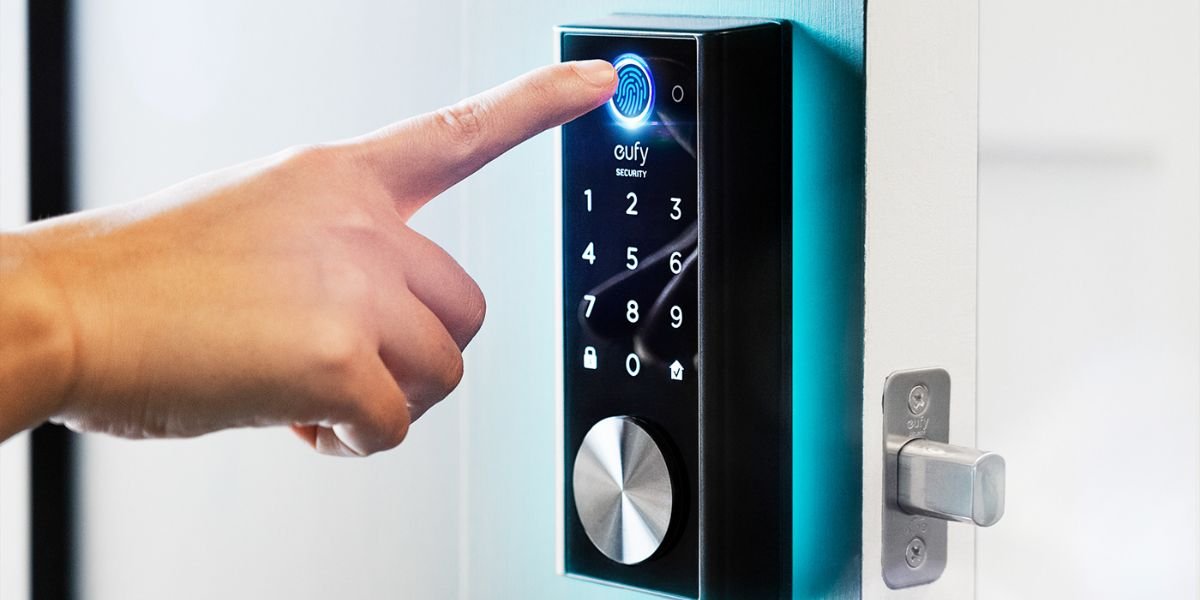 Person using fingerprint scanner on a smart digital door lock with keypad for home security