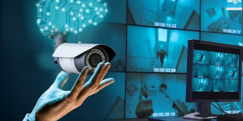 A hand holds a CCTV camera with a glowing circuit board design above it, set against a wall of video surveillance monitors.